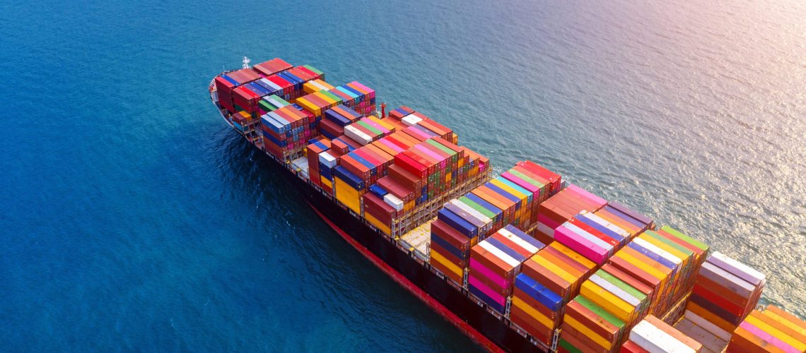 Aerial view of container cargo ship in sea.