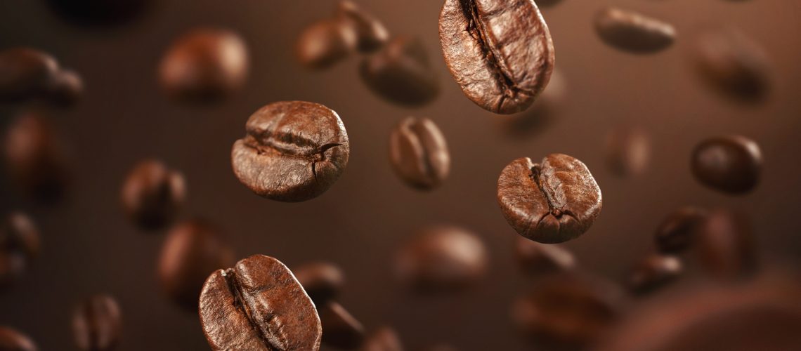 Roasted coffee beans falling down with copy space
