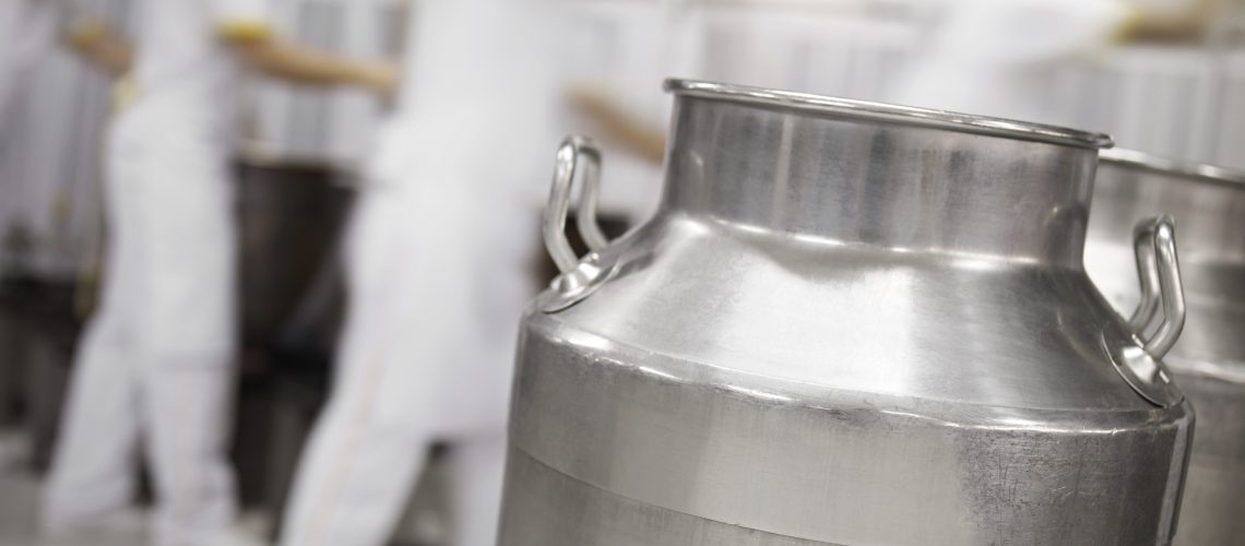 milk container in the foreground in a dairy factory