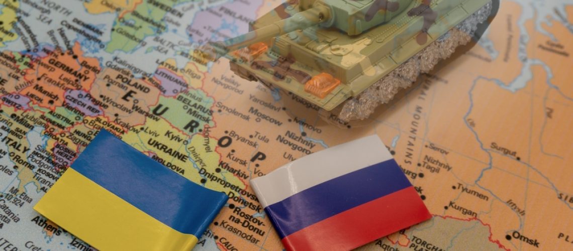 Ukrainian,And,Russian,Flags,Placed,On,A,Map,Of,Europe.
