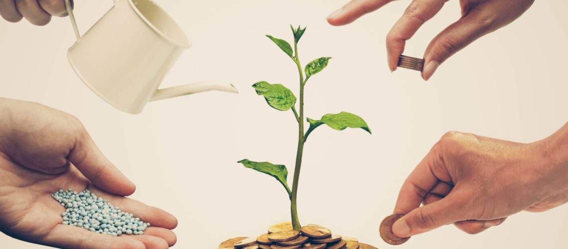 Cooperation,-,Hands,Helping,Planting,Trees,Growing,On,Coins,Together